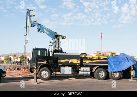 Eine Crew von Arbeitern Gießen Beton, der von einem Boom-Truck für ein neues Haus im Bau in Arizona gepumpt wird. Stockfoto