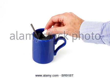 Hinzufügen eines Sugarlump zu einer frisch zubereiteten Tasse Kaffee Stockfoto