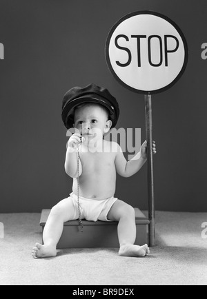 1940ER JAHRE BABY BOY HOLDING STOPPSCHILD VERKEHR PFEIFE Stockfoto