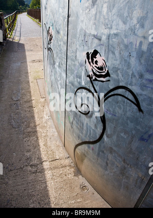 Banksy Stil gewundenen anthropomorphe rose Schablone Graffiti auf einem Metall Gebäude am Fluss Avon in Bristol Stockfoto