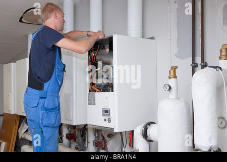 Heizungs- und Sanitär-Techniker testen und Anpassen einer Gasheizung Stockfoto