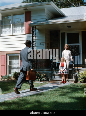 1950ER JAHRE MUTTER TOCHTER WARTEN SCHRITT S HAUS VATER AKTENTASCHE COMING HOME MANN FRAU MÄDCHEN FAMILIE RETRO Stockfoto