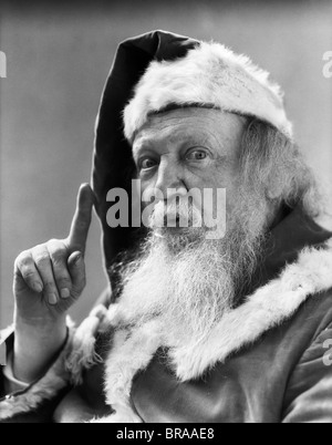 1930ER JAHRE PORTRAIT WEIHNACHTSMANN ZEIGT FINGER WARNUNG Stockfoto