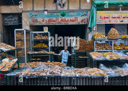 Kleiner Junge verkaufen frisches Brot in einer Bäckerei in der Altstadt von Kairo, Ägypten, Nordafrika Stockfoto