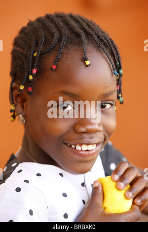 Afrikanische Mädchen essen eine Orange, Lome, Togo, Westafrika Stockfoto