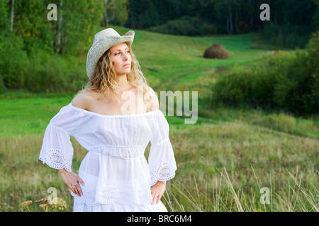 Schöne Frau zu Fuß in ein Feld. Stockfoto