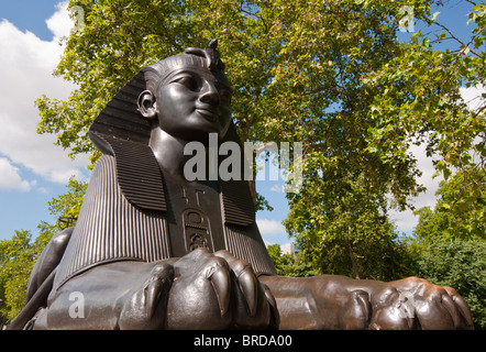 Eines der viktorianischen Sphinxen bewacht den ägyptischen Obelisk, bekannt als Kleopatras Nadel am Victoria Embankment in London England Stockfoto