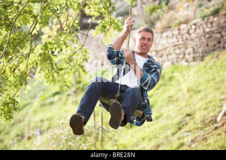 Menschen, die Spaß am Wald Swing im Herbst Stockfoto