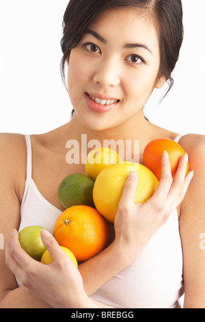 Junge Frau mit Zitrusfrüchten In Studio Stockfoto