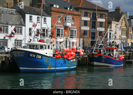 Zwei Fischerboote festgemacht in Weymouth Hafen und der Mündung des Fluss Wey in Weymouth, Dorset, England, UK Stockfoto