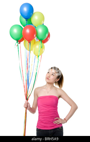 Junge Frau Holding Ballons Stockfoto