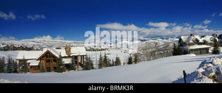 Panorama: sanfte Hügel im Winter, Koniferen und große Häuser, Cordillera, Colorado Stockfoto