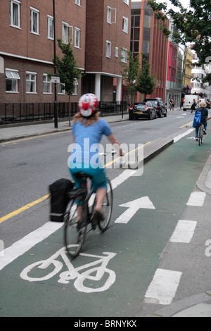 Weibliche Radfahrer (verschwommen) Radfahren einer Zweck Build-Zyklus Gasse auf Howland Street (an der Tottenham Court Road) London, UK. Stockfoto