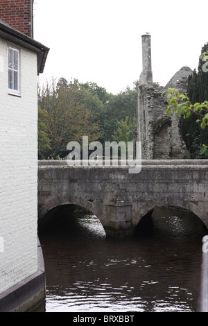 Ein kurzes Stück des Flusses Avon in Christchurch, Dorset, mit Bridge Street und die Ruinen des Hauses Polizisten hinter. Stockfoto