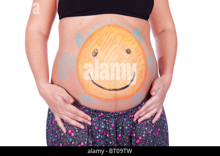 Schwangere Frau mit einem bemalten Bauch glücklich und lächelnd Teufelchen Stockfoto