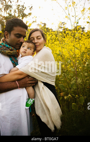 Familie umarmt im Feld Stockfoto