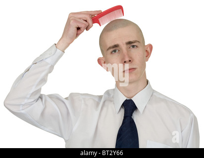 Absolut Glatzkopf mit einer Haarbürste in der hand Stockfoto