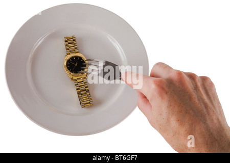 Die goldene Uhr auf den weißen Teller Stockfoto