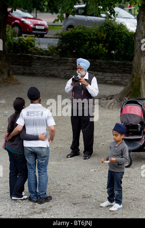 Asiatische gekleidete Touristen in Bowness auf Windermere am Lake Windermere Lake District Stockfoto