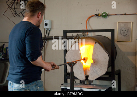 Island, Halbinsel Reykjanes, Keflavik. Glasbläser Werkstatt. Künstler, geschmolzenes Glas in die Heizung Ofen. Stockfoto