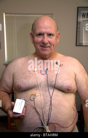 Amerikanische Mann trägt einen Holter-Monitor zur Überwachung der Herz für Herzrhythmusstörungen eingesetzt. HERR Stockfoto