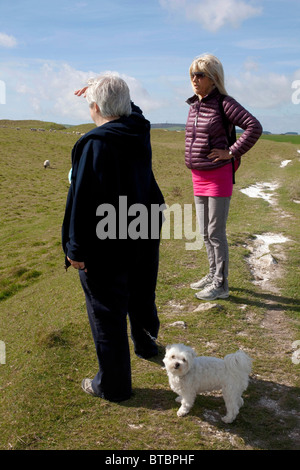 Rentnerinnen im Gespräch auf dem Fußweg in die Eisenzeit Wallburg von Maiden Castle, Dorchester, Dorset. DAVID MANSELL Stockfoto