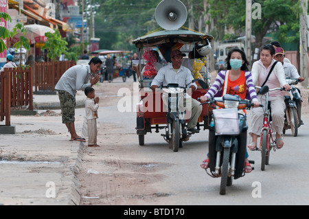 Eine Mobile buddhistische Nonne bietet Segen Pässe durch aus eine Autorikscha auf den Straßen von Siem Reap, Kambodscha Stockfoto