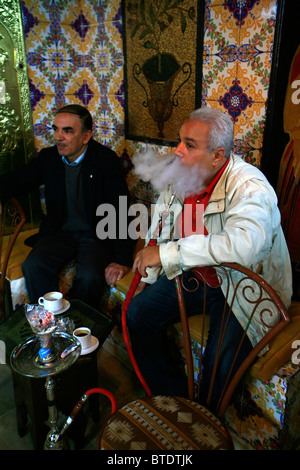 Mann Rauchen traditionelle Shisha-Wasserpfeifen in einem Café in der Medina in Tunis. Stockfoto