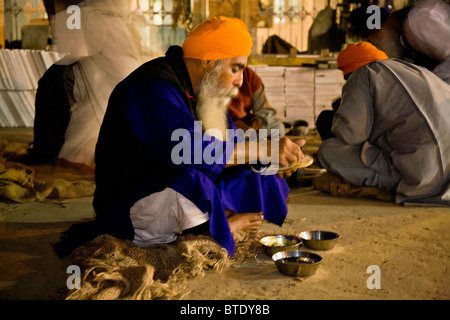 Sikh-Männer Abend Essen auf dem Boden des goldenen Tempels Langar, Amritsar, Punjab, Indien Stockfoto