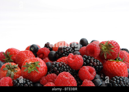 A low level view of a variety of berries against a white background Stockfoto