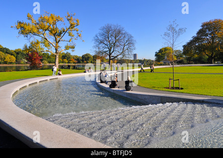 Prinzessin Diana Gedenkbrunnen im Hyde Park London England UK bilden eine kreisförmige Künstliche rill Wasserspiel mit Herbstfarben auf Bäumen Stockfoto