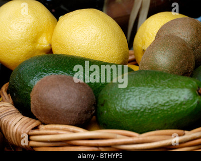 Zitronen, Kiwi und Avocado in einem Korb, UK Stockfoto