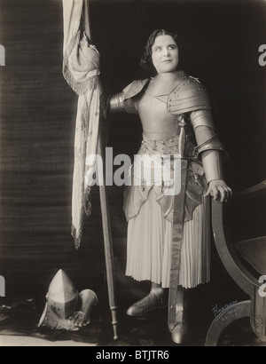 Geraldine Farrar (1882-1967), US-amerikanische Schauspielerin, gekleidet im Kostüm als Joan of Arc, hält eine Fahne, 1916. Stockfoto