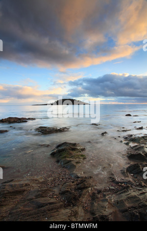 St Georges Insel gefangen genommen von den Felsen unter dem Deich am West Looe, Cornwall Stockfoto