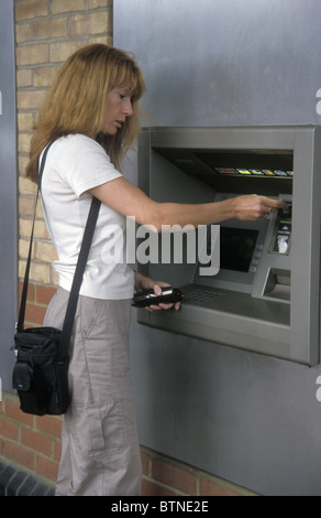 Frau am cashpoint Stockfoto