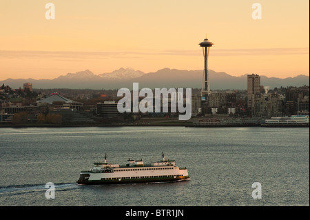 Ein wunderschönen Sonnenaufgang leuchtet der Space Needle und eine Fähre bringt Pendler in die Innenstadt von Seattle, Washington, USA. Stockfoto