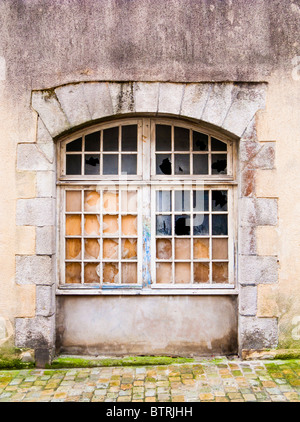 Gewölbte Fenster mit zersprungenen Fensterscheiben aus Glas Stockfoto