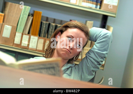 Studentische Arbeiten/studieren in einer Bibliothek vor einem Stichtag betont. Stockfoto