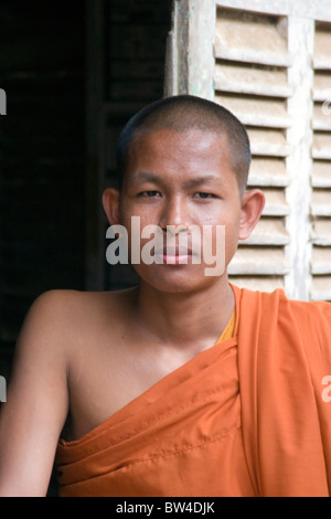Ein buddhistischer Mönch posiert für ein Porträt von einem Fenster im Wat Bangkok in Kampong Cham, Kambodscha. Stockfoto