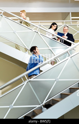 Foto von anstrengenden Partnern kommunizieren beim Treppensteigen im Bürogebäude Stockfoto