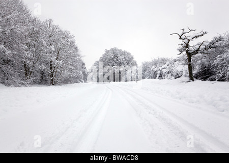 Reifenspuren im Schnee auf einer Landstraße in England Stockfoto