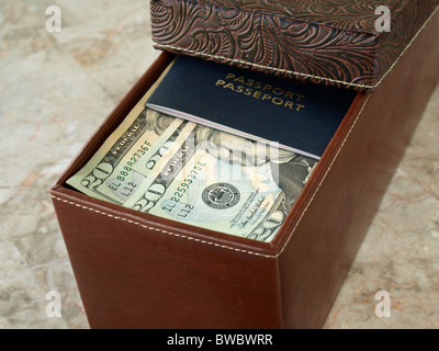Braune Leder-Box mit us-Dollar und Pass auf den Tisch Stockfoto