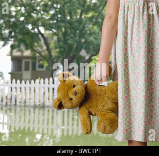 USA, Illinois, Metamora, Mädchen (8-9) Holding Teddy im überfluteten Hof Stockfoto