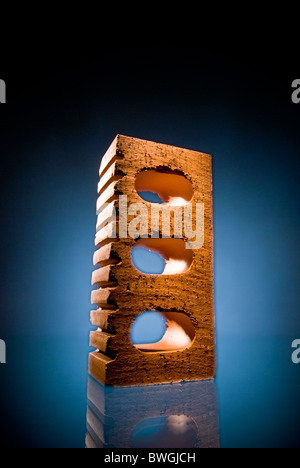 Beautifully lit single house brick on a blue background Stockfoto