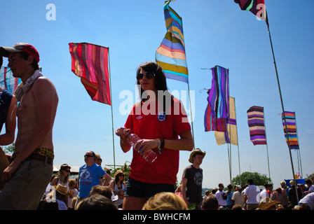 Frau in einem roten England Fußball Hemd zu Fuß durch Massen von Menschen, die Standortwahl auf dem Boden beim Glastonbury Festival 2010 Stockfoto