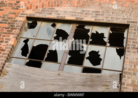 Zertrümmerte Fenster in einem verlassenen Fabrikgebäude. Detroit, Michigan, USA. Stockfoto