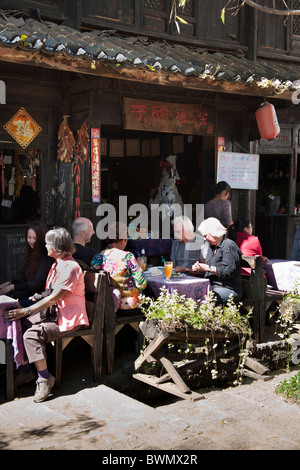 Westliche Touristen Essen im Freien ein Restaurant Baisha Dorf in der Nähe von Lijiang, Provinz Yunnan, China Stockfoto