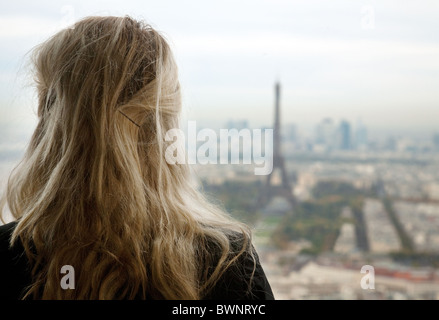 Eine junge blonde Frau, Blick auf den Eiffelturm vom Dach des Tour Montparnasse, Paris, Frankreich Stockfoto