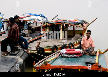 Ein Fährmann entspannt auf einer Fähre am Fluss Hooghly am Howrah Ufer in der Nähe von Kolkata Stockfoto