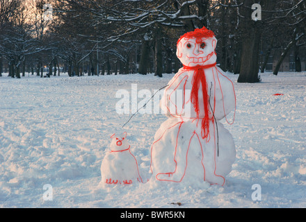 Ein "Cartoon" Schneemann mit seinem Hund, hergestellt aus Schnee und Wolle, stehen auf den Wiesen in Edinburgh, Schottland, Großbritannien. Stockfoto